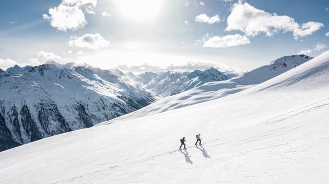 two man hiking on snow mountain 869258